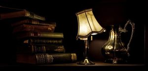 ancient-lamp-with-silver-jug-and-books-on-table