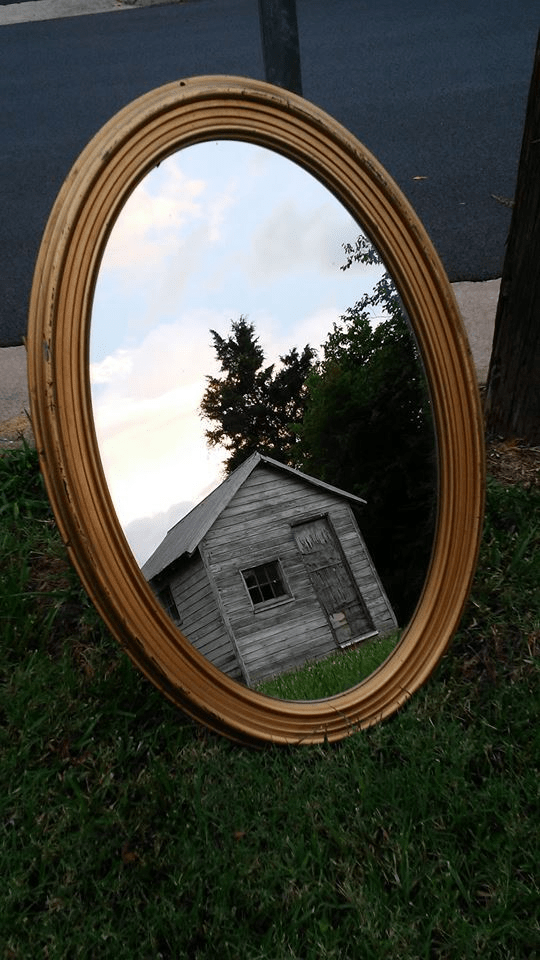 mirror reflecting old shed