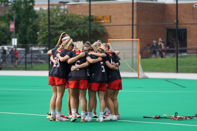 girls-in-huddle-on-soccer-field