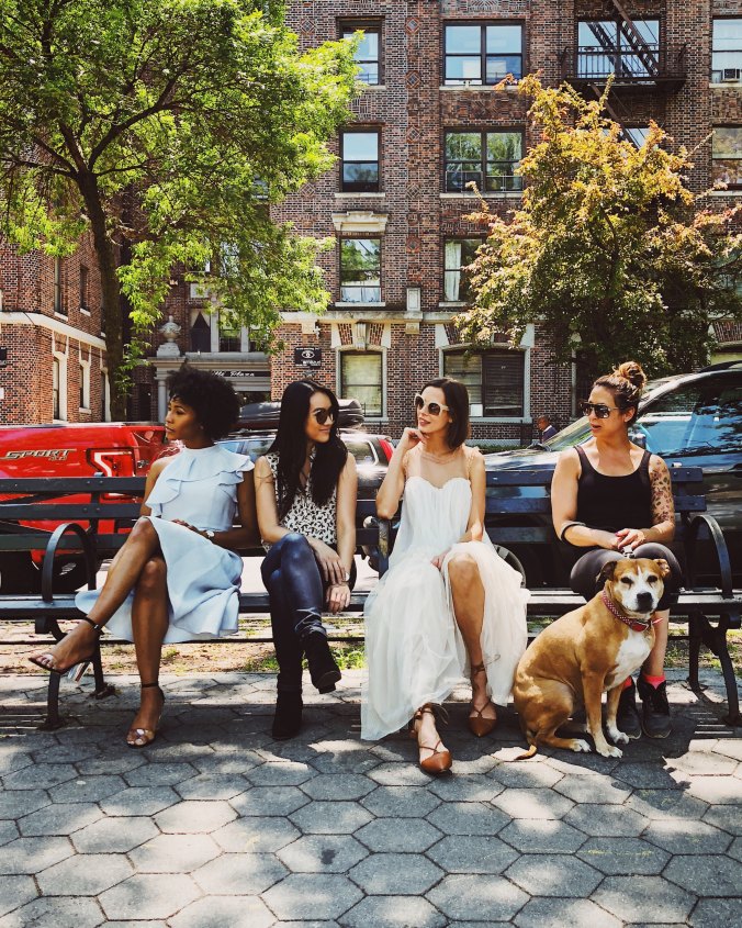 four-women-siting-on-a-NYC-park-bench