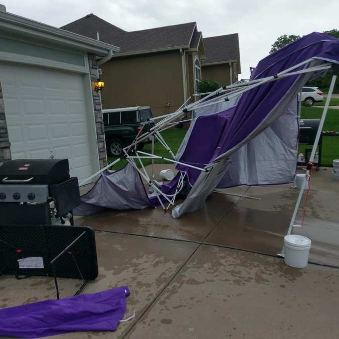 demolished-purple-tent on driveway with grills